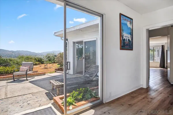 a view of a patio with table and chairs potted plants with wooden floor