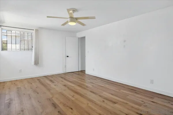 a view of a house with a yard and potted plants