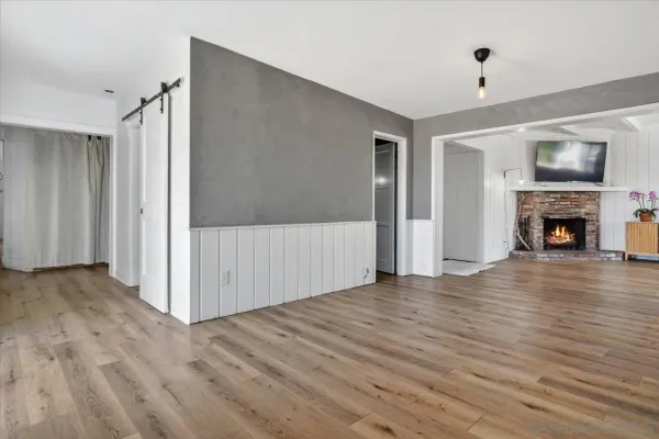 a bathroom with a granite countertop sink a toilet and mirror