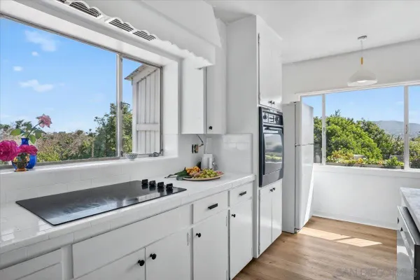 a view of a room with wooden floor
