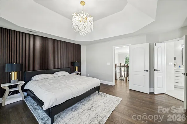 a bed room with a bed and a chandelier