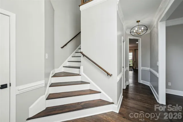 a view of a hallway with wooden floor and entryway