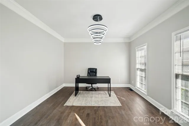 a view of a livingroom with furniture wooden floor and a window