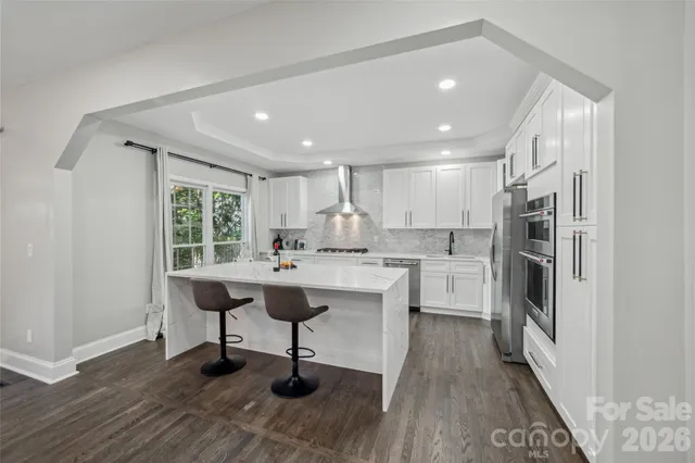 a kitchen with refrigerator cabinets and wooden floor