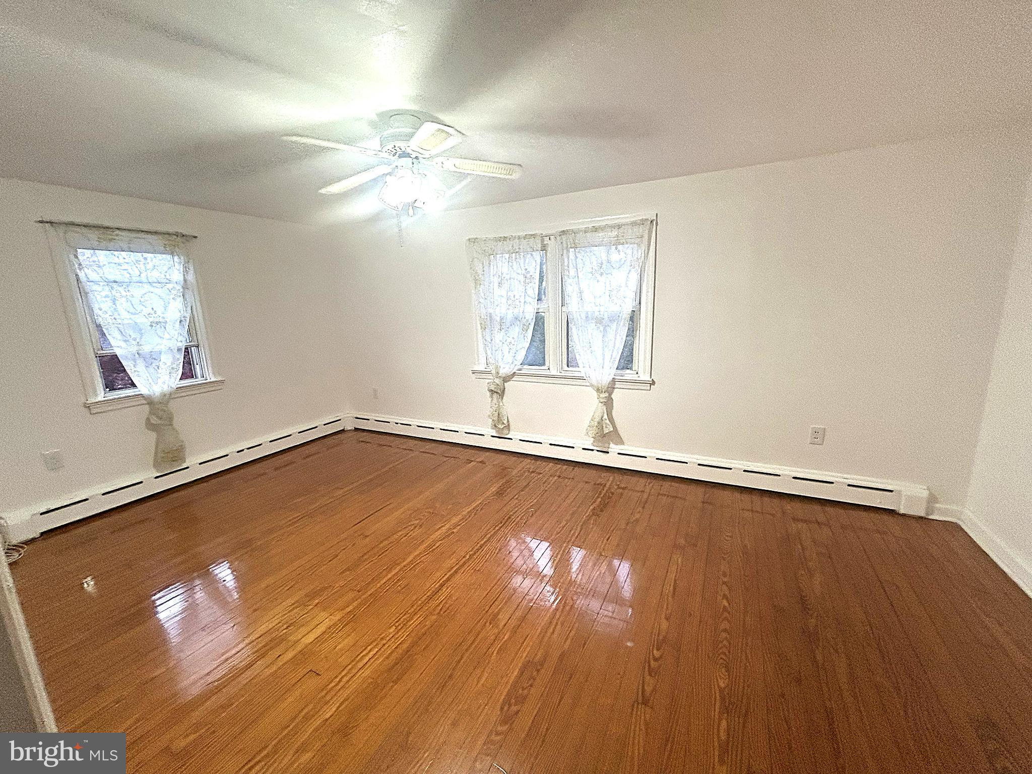 625 Grove Street Bridgeport, PA 19405 - Photo 11 of 15 an empty room with wooden floor and windows