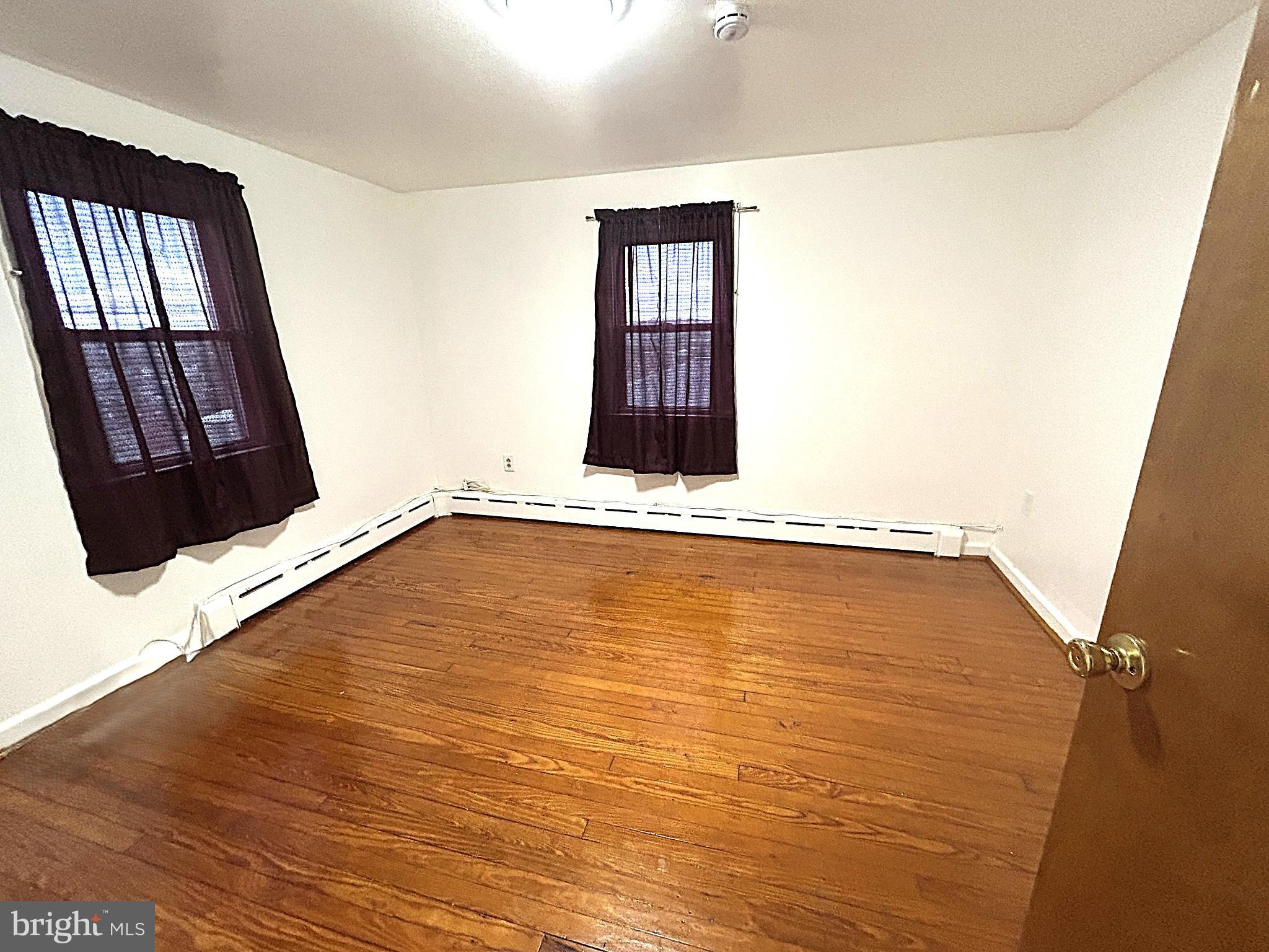 625 Grove Street Bridgeport, PA 19405 - Photo 13 of 15 a view of an empty room with wooden floor and a window