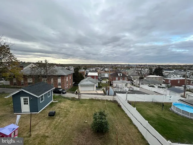an aerial view of a house with swimming pool and lake view