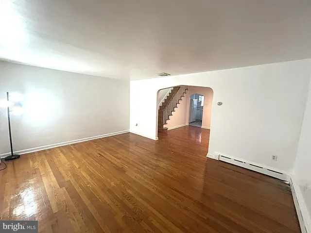 a view of a room with wooden floor