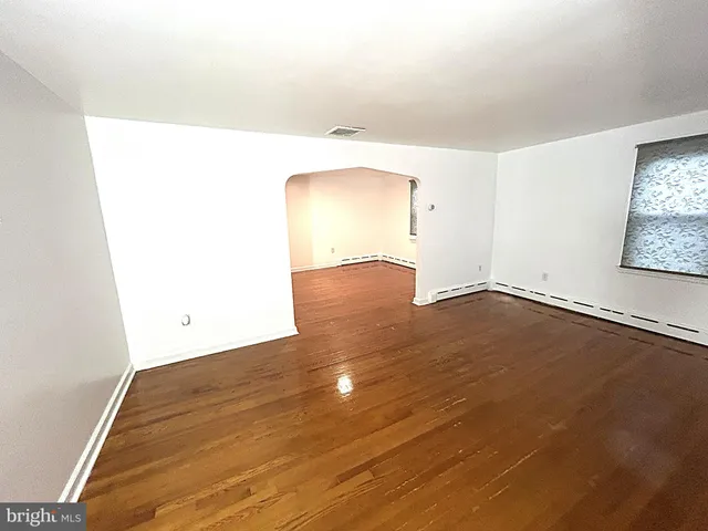 a view of a room with wooden floor