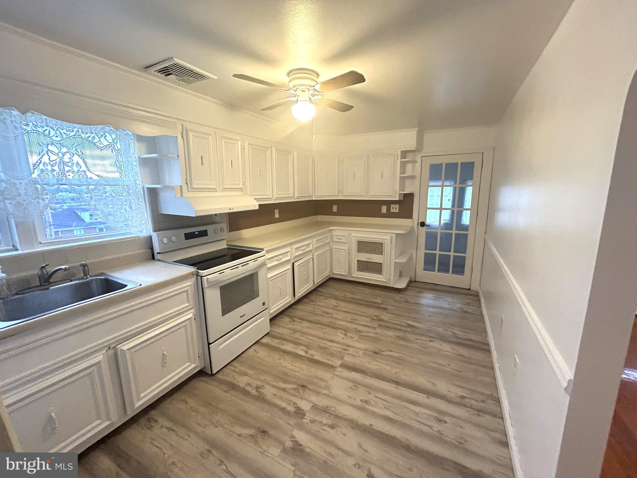 625 Grove Street Bridgeport, PA 19405 - Photo 8 of 15 a kitchen with white cabinets and white appliances