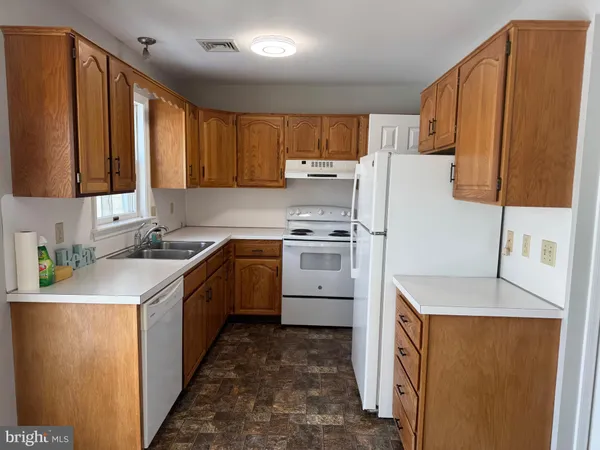 a kitchen with a sink a refrigerator and a stove