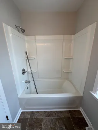 a bathroom with a bathtub and shower