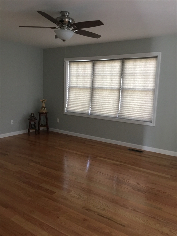 367 County Street Fall River, MA 02723 - Photo 4 of 8 a view of an empty room with wooden floor and a window