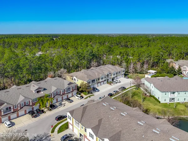 an aerial view of a house with a big yard
