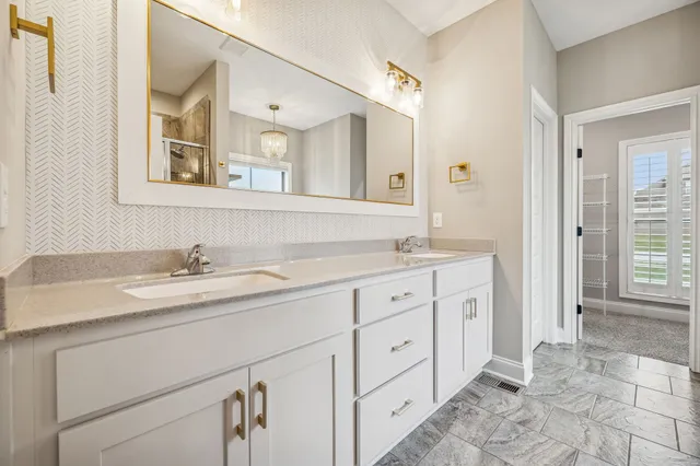 a bathroom with a sink toilet vanity and shower