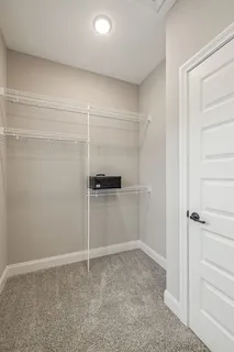 an empty room with a ceiling fan and a window