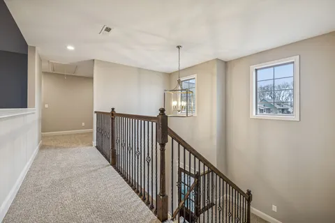 an empty room with a ceiling fan and window
