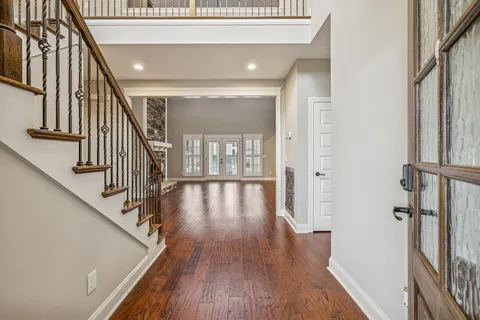 a view of an entryway with wooden floor and stairs