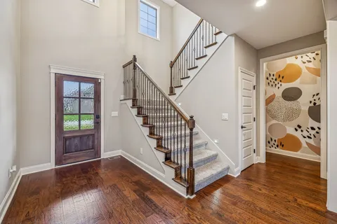 a view of an entryway with wooden floor