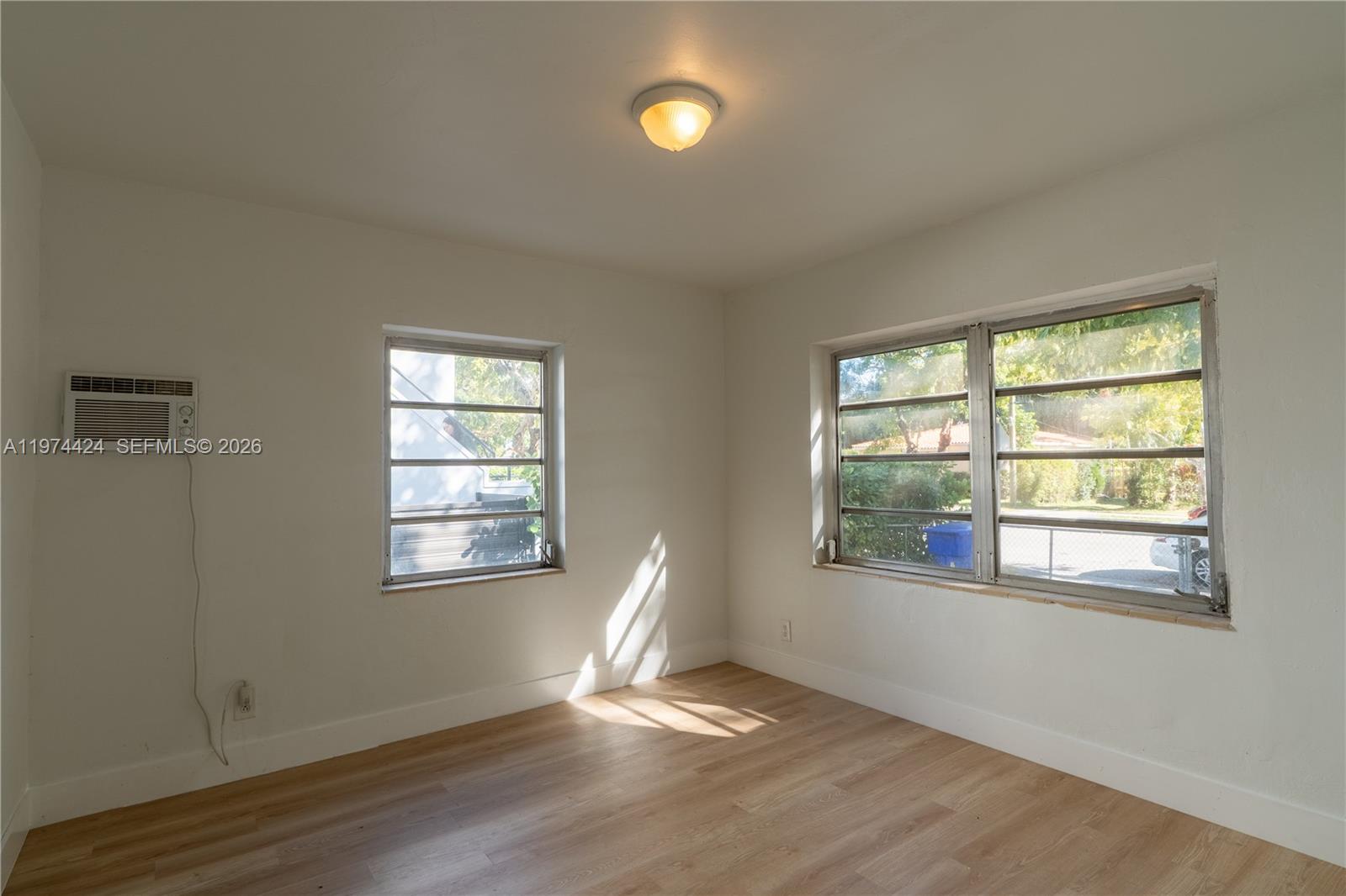 3665 Southwest 16th Street, Unit 3665 Miami, FL 33145 - Photo 11 of 25 a view of an empty room with wooden floor and a window