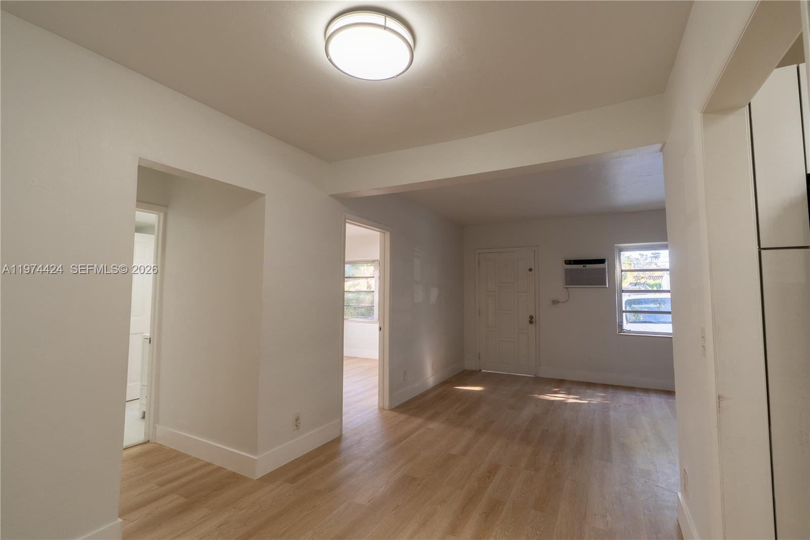 3665 Southwest 16th Street, Unit 3665 Miami, FL 33145 - Photo 16 of 25 an empty room with wooden floor and windows