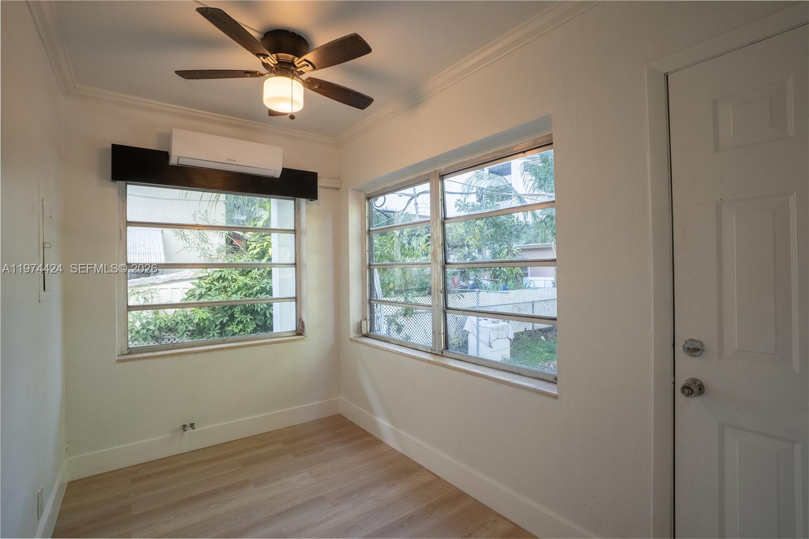 3665 Southwest 16th Street, Unit 3665 Miami, FL 33145 - Photo 17 of 25 a view of an empty room with a window and wooden floor