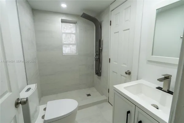 a bathroom with a sink toilet and shower