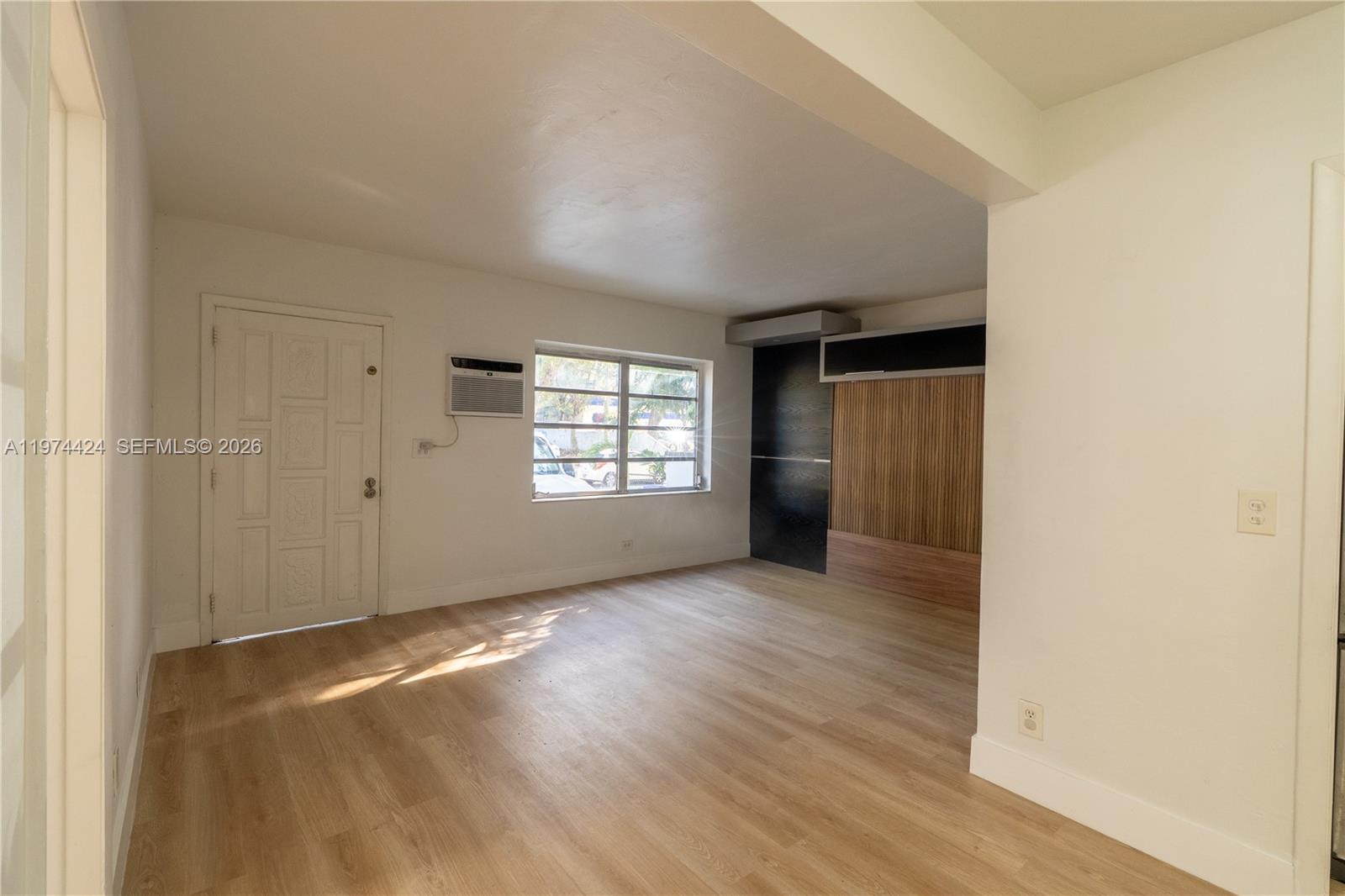 3665 Southwest 16th Street, Unit 3665 Miami, FL 33145 - Photo 5 of 25 an empty room with wooden floor and windows
