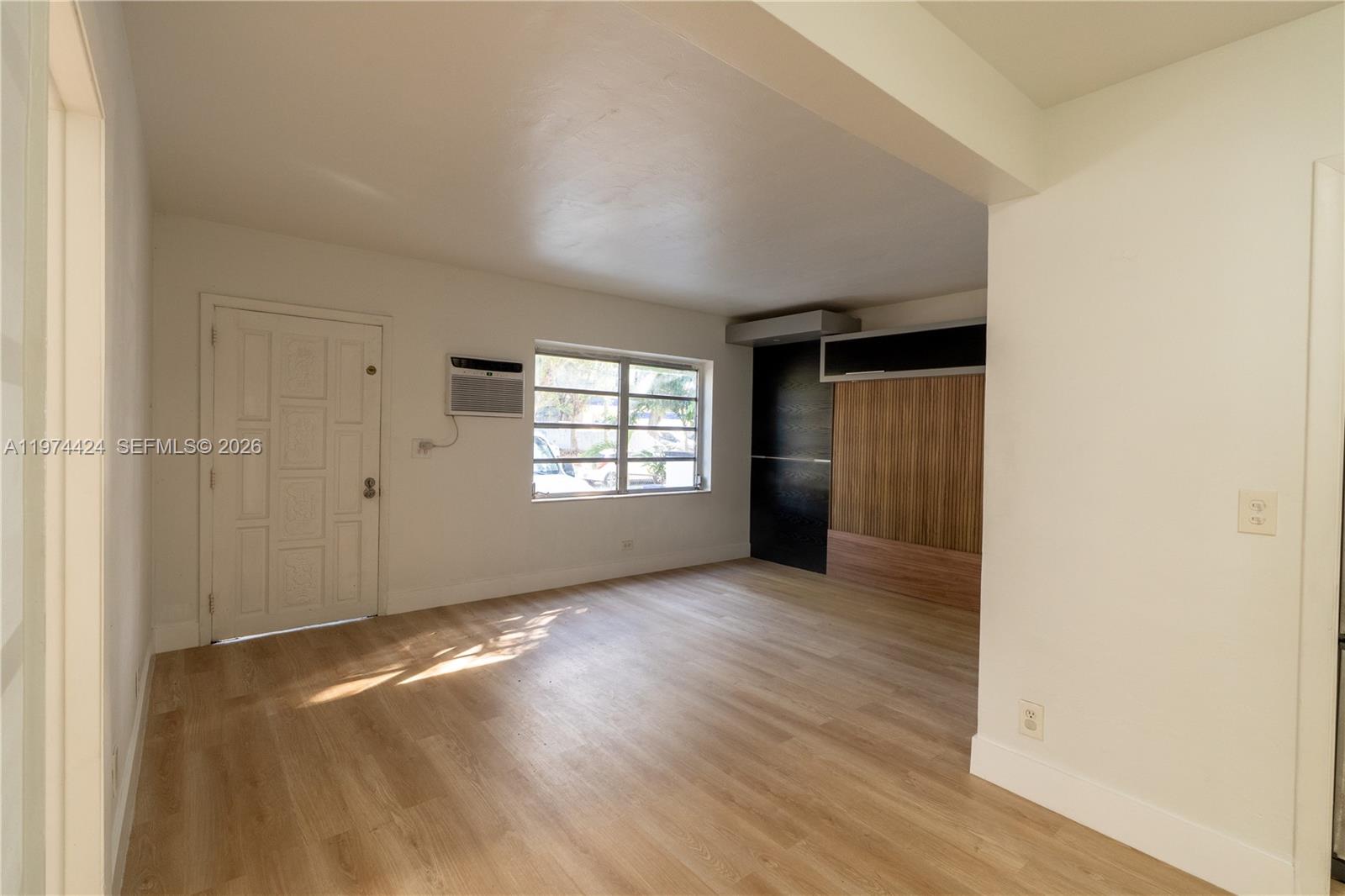 3665 Southwest 16th Street, Unit 3665 Miami, FL 33145 - Photo 6 of 25 an empty room with wooden floor and windows