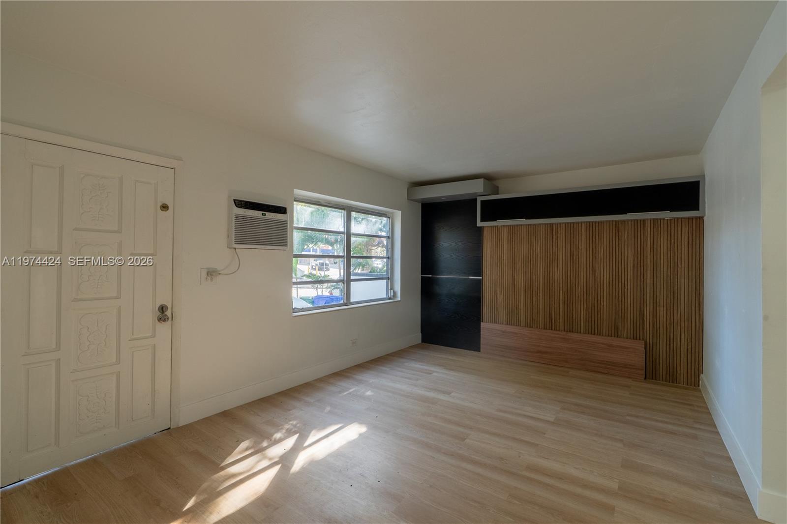 3665 Southwest 16th Street, Unit 3665 Miami, FL 33145 - Photo 7 of 25 wooden floor in an empty room with a window