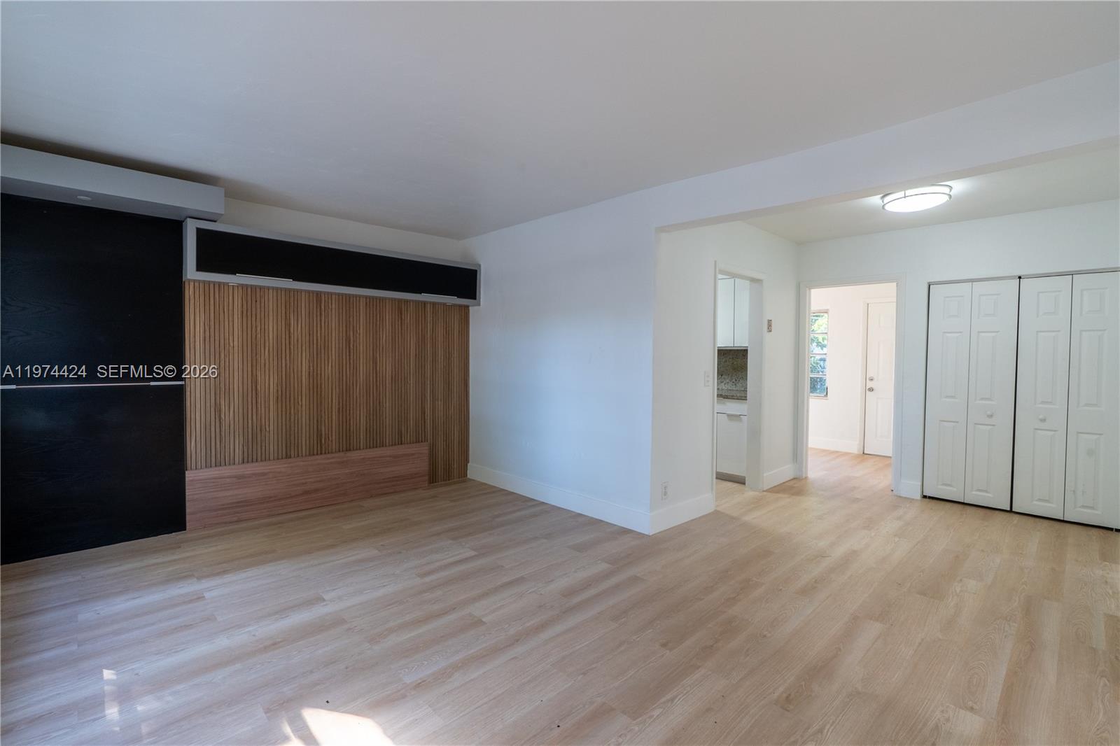 3665 Southwest 16th Street, Unit 3665 Miami, FL 33145 - Photo 8 of 25 a view of an empty room with wooden floor and a cabinet
