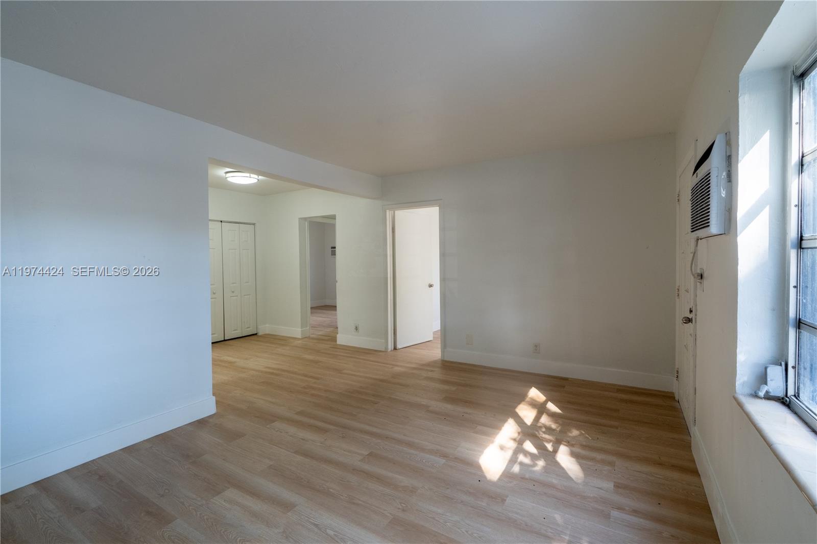 3665 Southwest 16th Street, Unit 3665 Miami, FL 33145 - Photo 9 of 25 a view of an empty room with wooden floor and a window