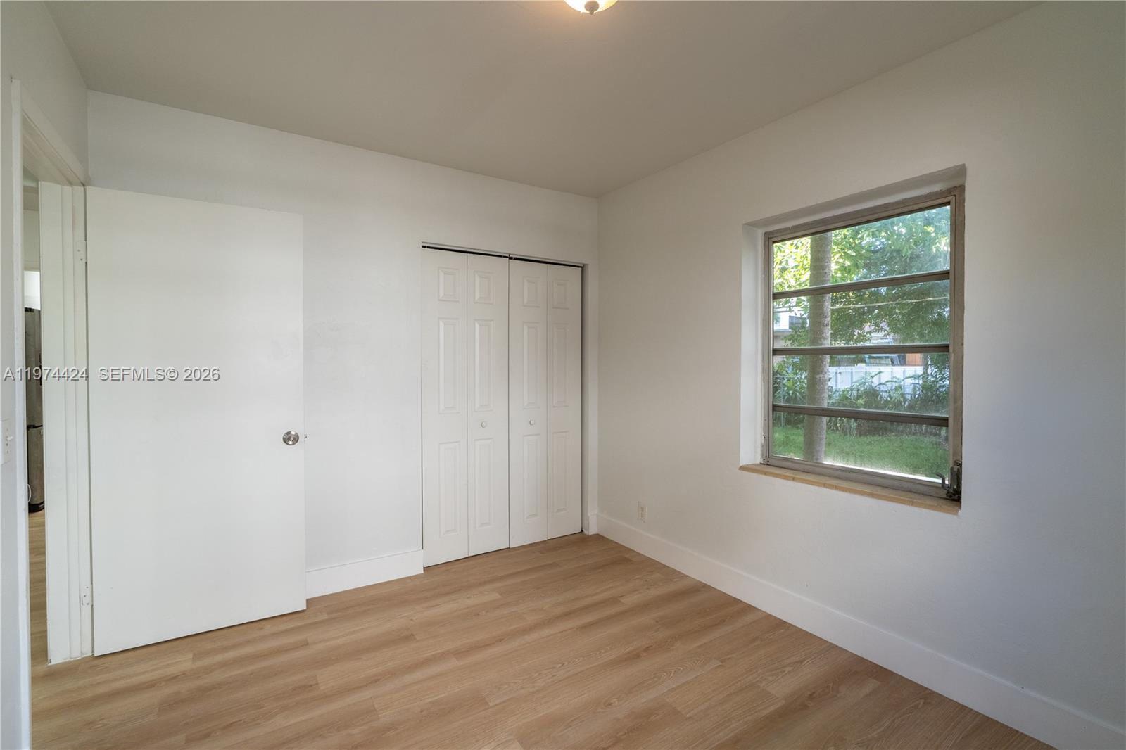3665 Southwest 16th Street, Unit 3665 Miami, FL 33145 - Photo 10 of 25 a view of an empty room with wooden floor and a window