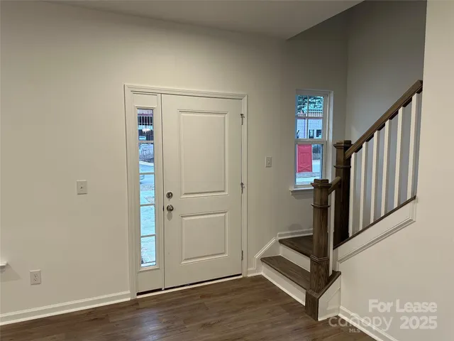 a view of an entryway with wooden floor