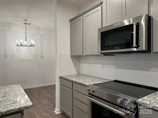 a kitchen with a stove and a microwave