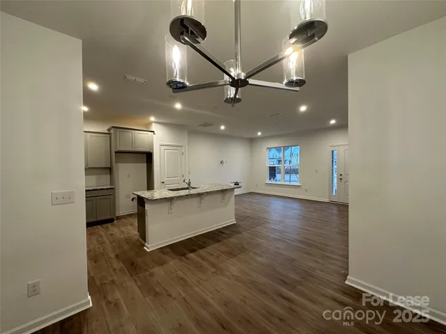 a large kitchen with a large counter top appliances and cabinets