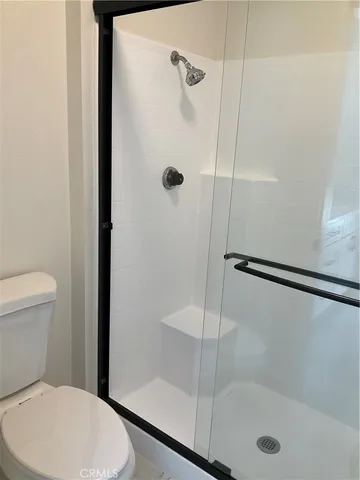 a bathroom with a shower a toilet and a shower