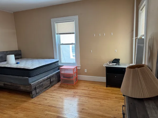 a bed room with a bed and a window