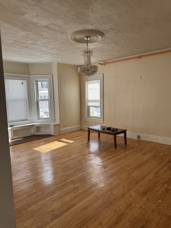 93 Fairfax Road Worcester, MA 01610 - Photo 17 of 35 a view of empty room with wooden floor and fan