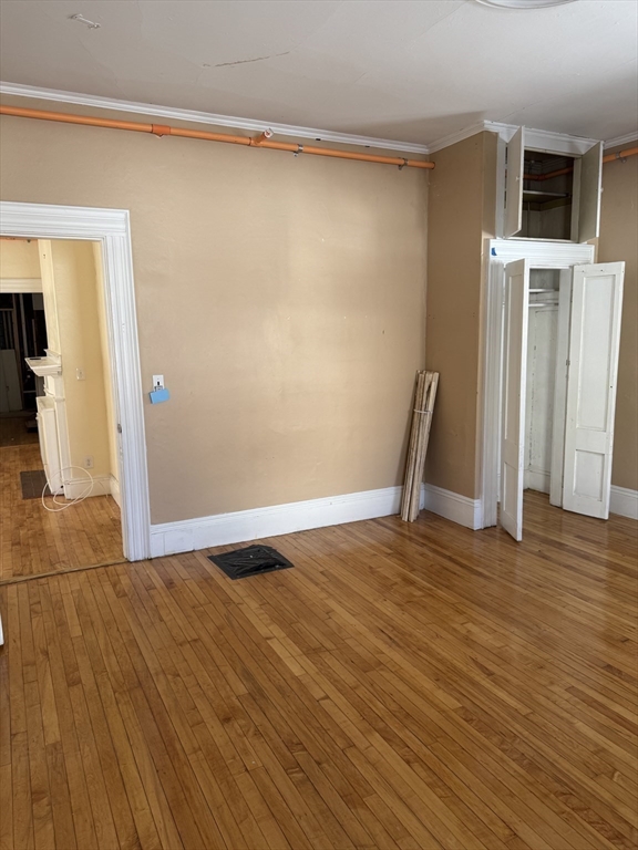 93 Fairfax Road Worcester, MA 01610 - Photo 18 of 35 a view of an empty room with wooden floor and a window