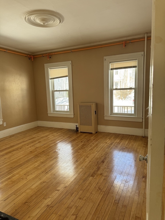 93 Fairfax Road Worcester, MA 01610 - Photo 19 of 35 an empty room with wooden floor and windows