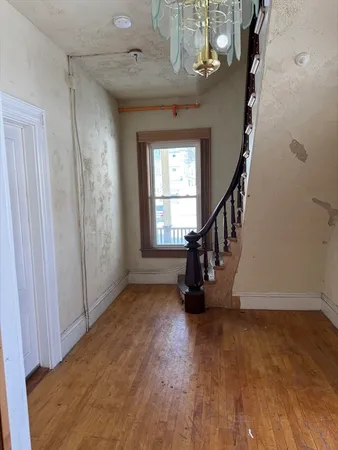 a view of entryway and hall with wooden floor