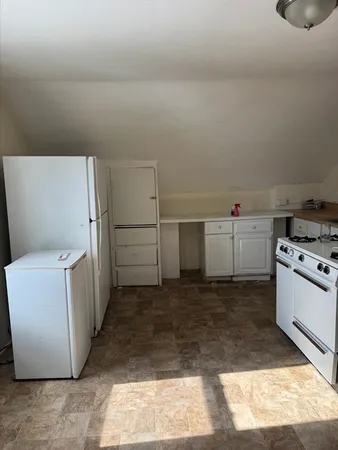 a kitchen with cabinets and white appliances