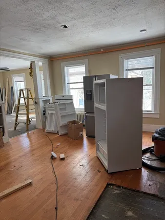 a view of a kitchen with furniture and wooden floor