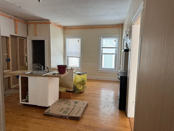 a living room with stainless steel appliances kitchen island granite countertop furniture and a window