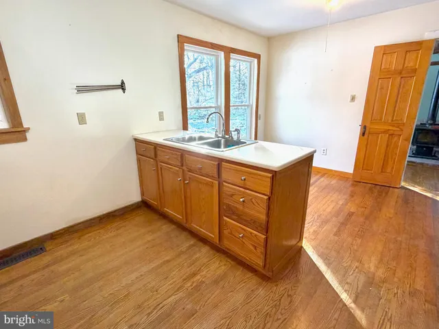 a room with wooden cabinets and a sink