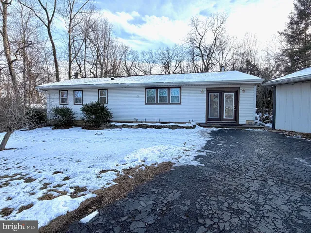 a view of a house with a yard covered with snow in the background