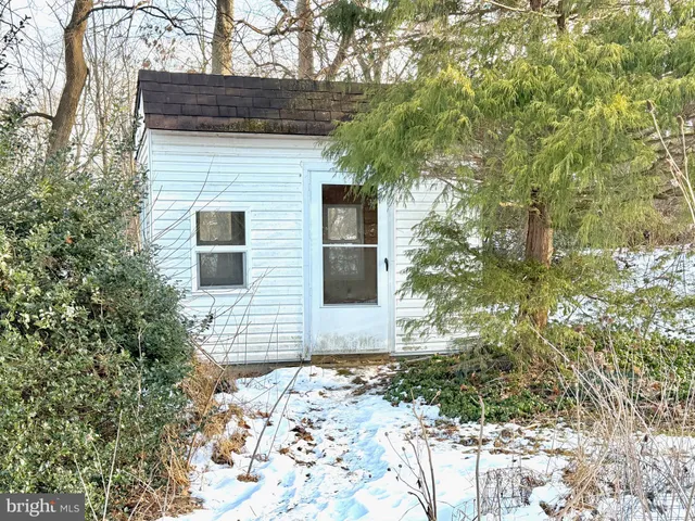a brick house with a large tree