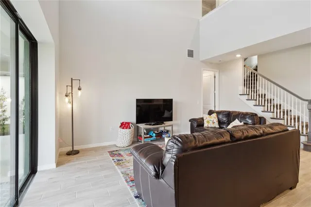 a living room with furniture and a view of kitchen