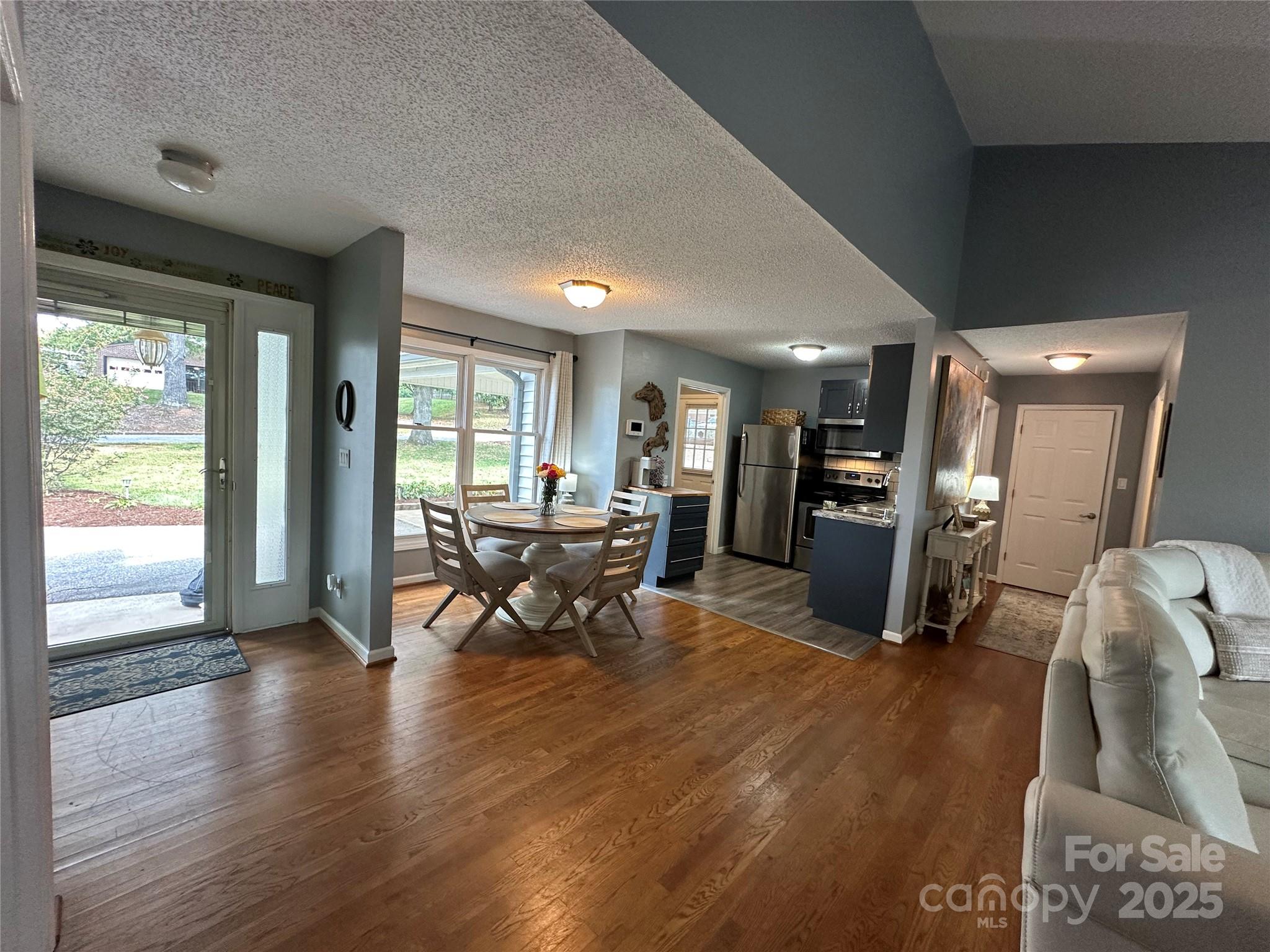 102 Stephens Drive Morganton, NC 28655 - Photo 11 of 48 a living room with furniture dining table and wooden floor